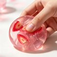 thumbnail image 2 of Strawberry Fruit Squishy Toy, Transparent Plastic Sensory Fidget with Pink Slice Details for Study Breaks, 2 of 6