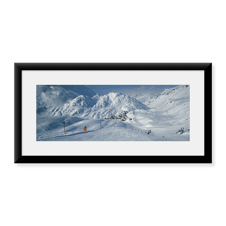 Framed Art Print, Rear view of a person skiing in snow by Panoramic Images, 25-7/8" x 9-7/8"