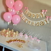 Pink and Gold Essentials Party Package. Ships in 1-3 Business Days. Balloons, Crowns, Straws, Cups, Plates, Wands, Confetti and Banner.
