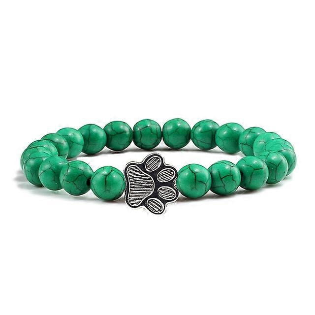 Pulsera con dije de huella de pata de piedra volcánica de lava negra mate natural, ideal como recuerdo para mascotas, amantes de los gatos y los perros.