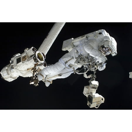 Astronaut anchored to a Canadarm2 mobile foot restraint Stretched Canvas - Stocktrek Images (34 x