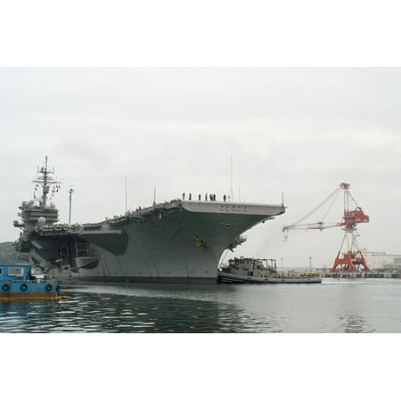 LAMINATED POSTER Large harbor tugs assist USS Kitty Hawk (CV 63) as she returns to her forward deployed base after co Poster Print 24 x