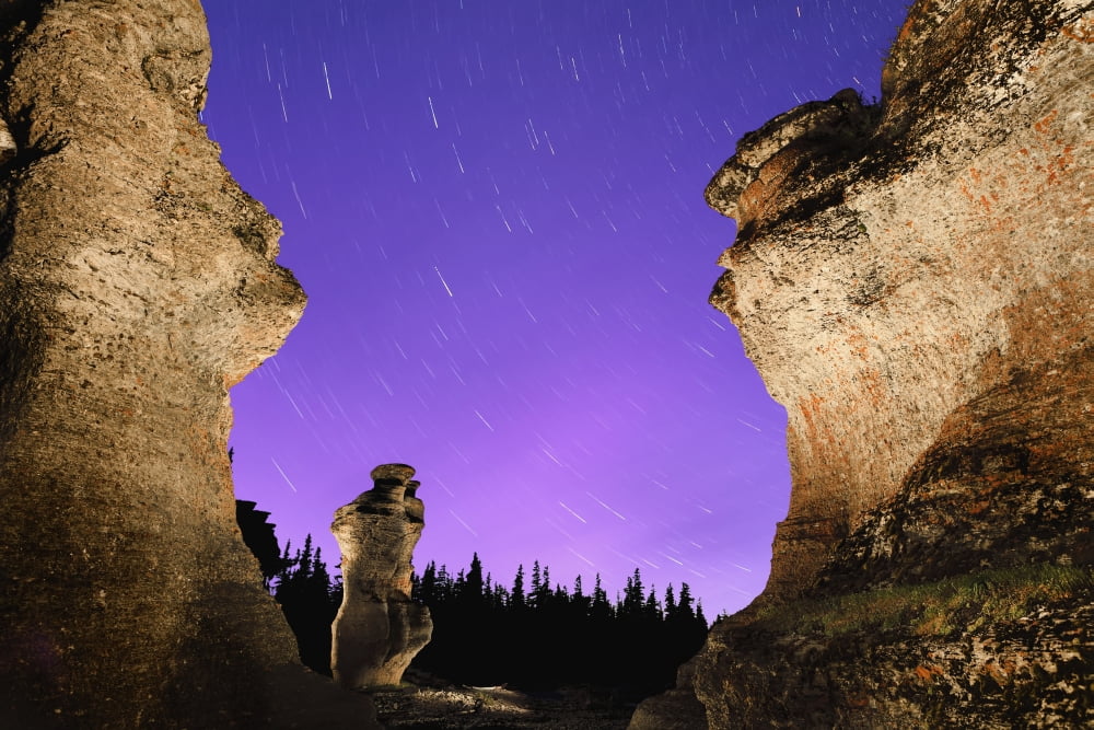 Light painting on monolith and star trails Anse des Bonnes Femmes at Ile Niapiskau Mingan Archipelago National Park Reserve of Canada Cote-Nord Duplessis region Quebec Canada Canvas Art - Yves Marcoux