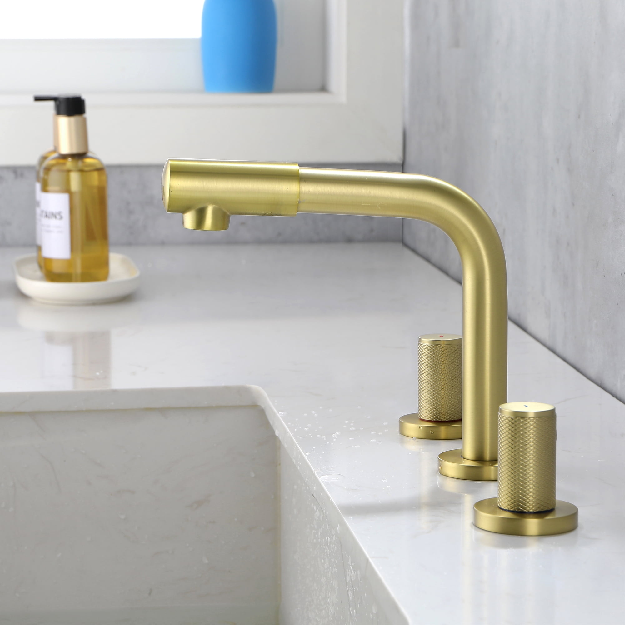 Three hole faucet with brushed gold water outlet nozzle that can rotate