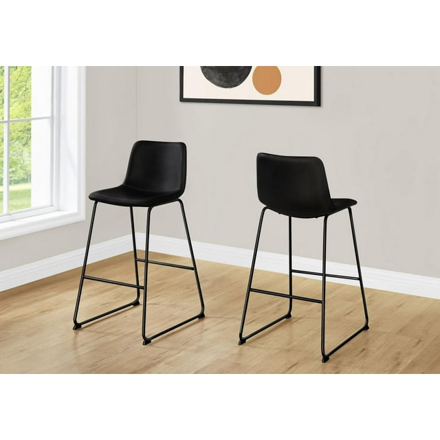 Monarch Specialties black bar height office chairs with metal frames and PU leather look seats, shown in a contemporary workspace.