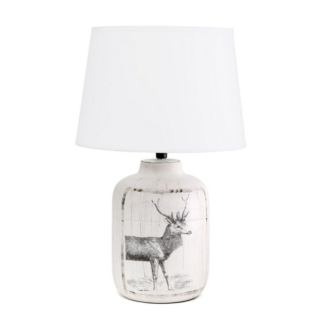 Farmhouse style ceramic accent table lamp featuring a rustic deer buck print on the base and topped with a white fabric shade.