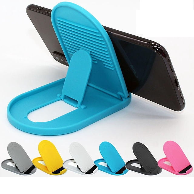 soporte plegable para teléfono celular de 6 piezas, soporte ajustable para teléfono celular, universal para todos los teléfonos celulares y tabletas; soporte azul abierto en primer plano sosteniendo un smartphone en horizontal, base ovalada de plástico con respaldo articulado estriado y pestaña de apoyo. Muestra los seis colores disponibles (rosa, azul, negro, blanco, gris, amarillo), tamaño aprox. 11 x 6.6 cm, paquete de 6 piezas; también suele usarse para sostener tablets pequeñas en mesa.
