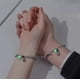 thumbnail image 4 of Set 2 Pulseras Para Parejas Imán Astronauta Brilla Oscuridad Modelo Gris, 4 of 4