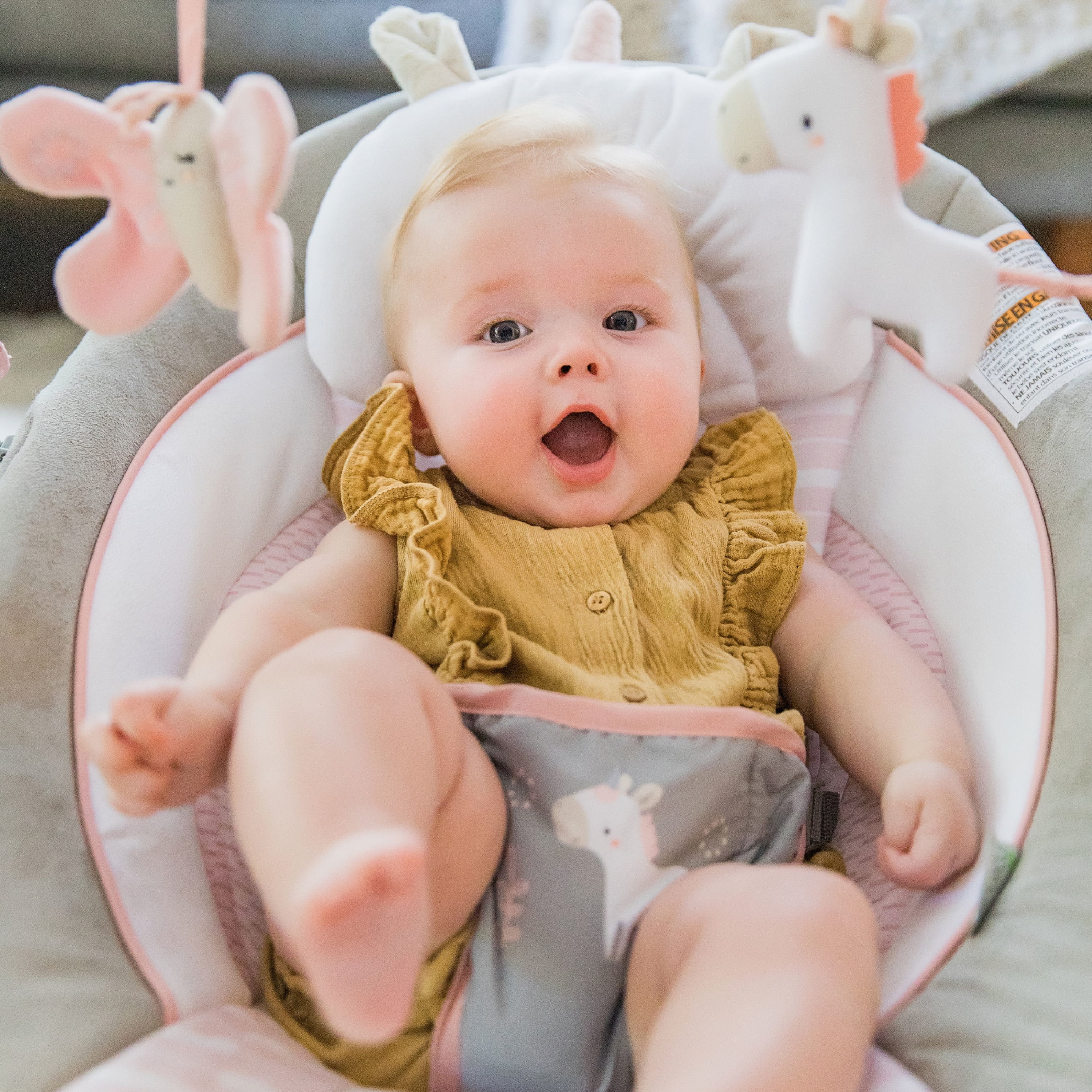 audrey cradling bouncer in pink