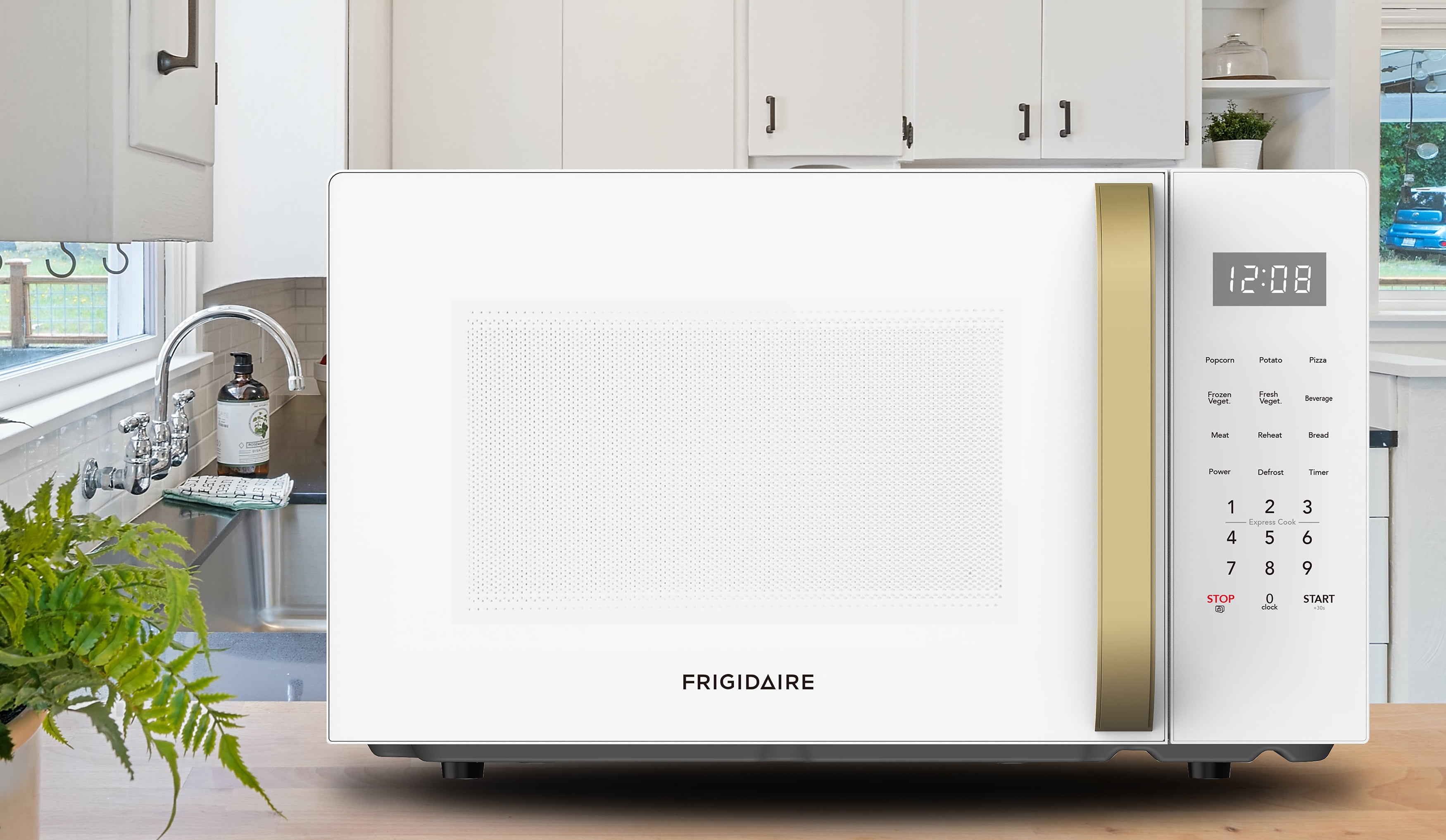 Frigidaire 1.1 cu. ft. 900 Watt Countertop Microwave, White and Gold