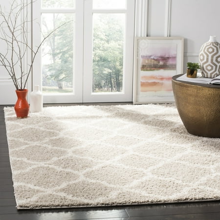 Safavieh New York Shag SG168 Indoor Area Rug The quatrefoil design and plush  shag texture of the Safavieh New York Shag SG168 Indoor Area Rug can accent your transitional or global living or dining room. This cozy rug feels great under your feet and has a solid-colored background with a contrasting  light quatrefoil pattern from edge to edge. Choose from available colors.