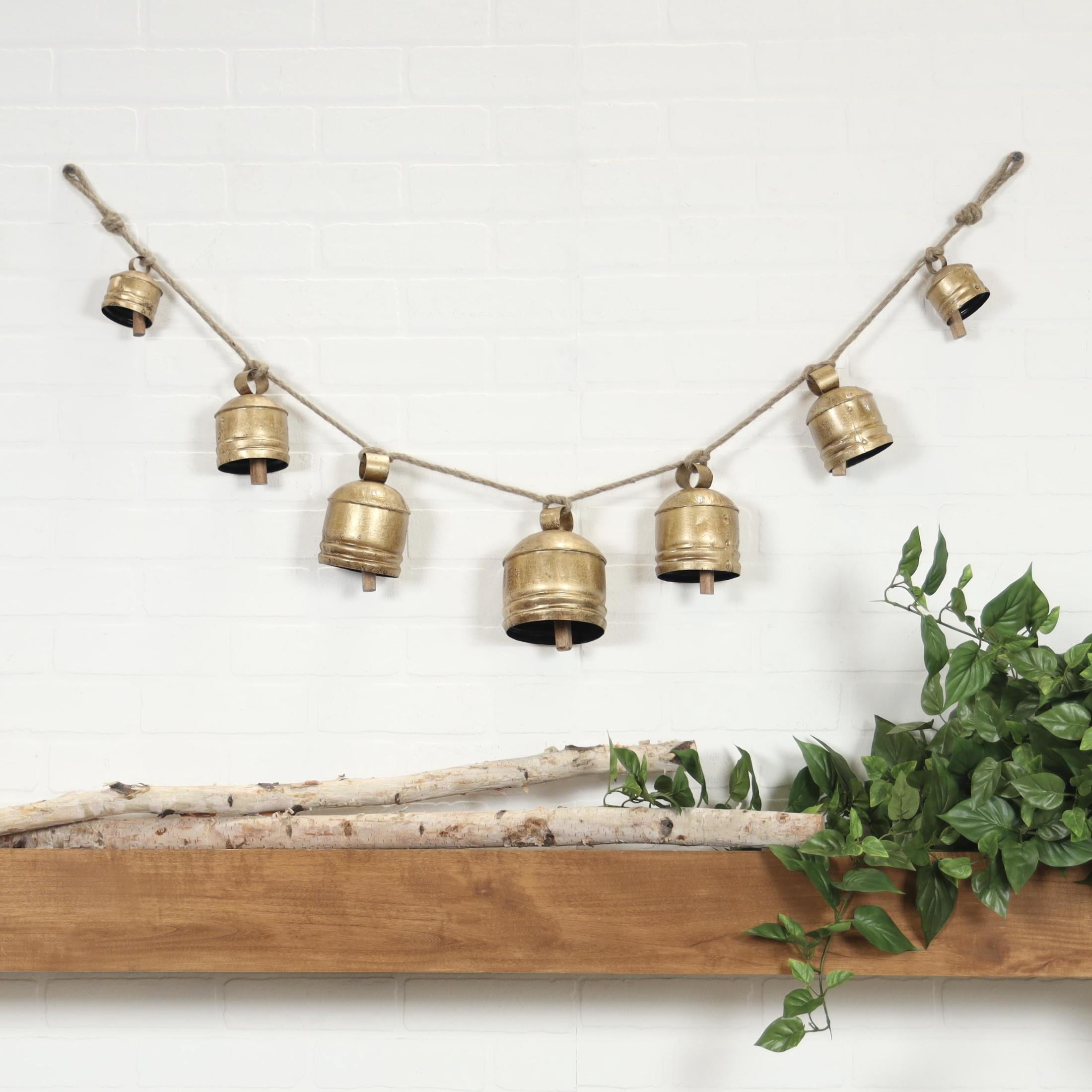 DecMode Tibetan Inspired Gold Metal Cylindrical Decorative Cow Bells with 7 Bells on Jute Hanging Rope