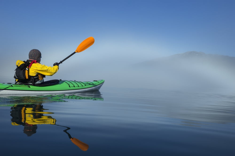 A Sea Kayaker Paddles Along The Edge Of A Thick Fog Bank In Southeast Alaskas Stephens Passage A Fog Bow Has Formed Where Water Particles Reflect The Light Of The Morning Sun Mr Ed Emswiler Id#1217201