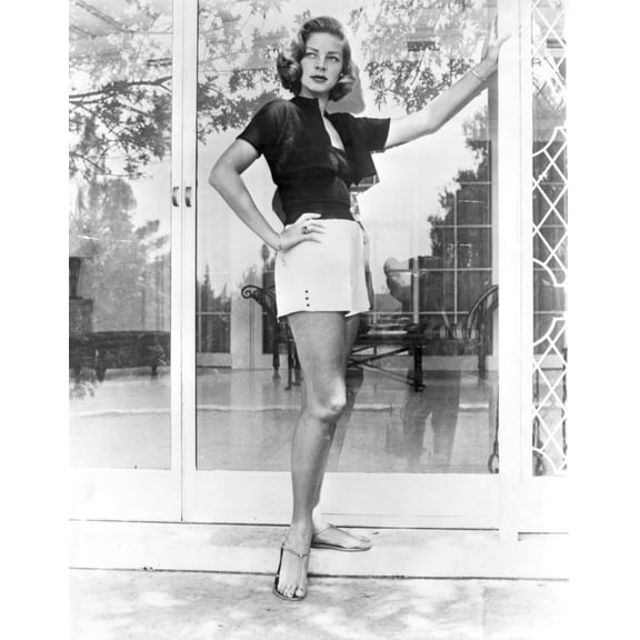 Lauren Bacall wearing shorts by a door Photo Print (24 x 30)