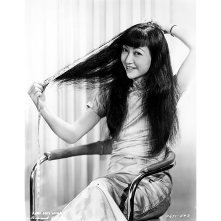 Anna Wong sitting on a Chair and Fixing Her Hair Photo