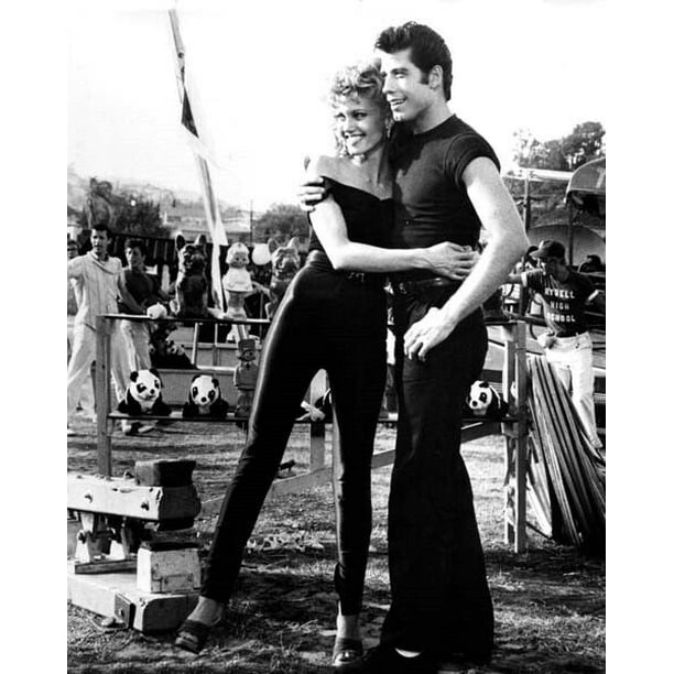 Grease Olivia NewtonJohn & John Travolta at fun fair hug each other
