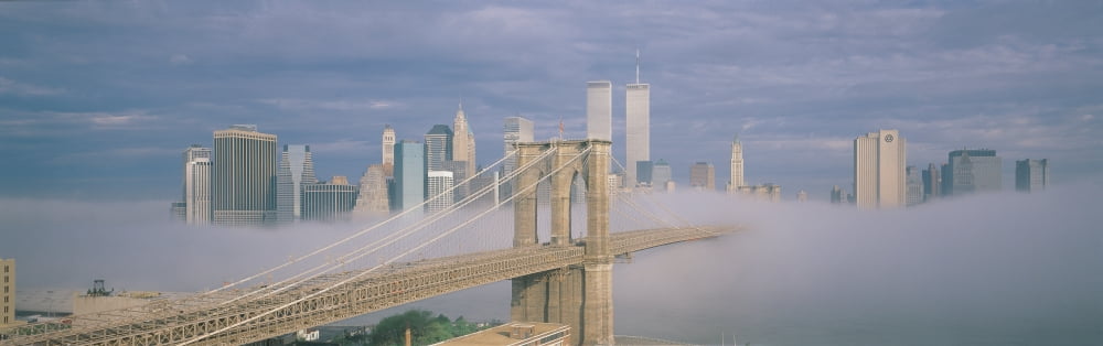 This is the Brooklyn Bridge over the East River with the Manhattan skyline behind it There is a morning fog enveloping the bridge and make it look like the Emerald City in the Land of Oz Canvas Art -