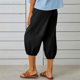 thumbnail image 4 of Pantalones harem elásticos de cintura alta y corte holgado para mujer: pantalones cortos informales con bolsillos, mezcla de algodón, diseño de color liso, 4 of 8
