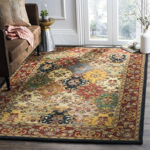 SAFAVIEH Heritage Malcolm traditional wool area rug featuring a multicolor floral and geometric design with red border in a living room setting.