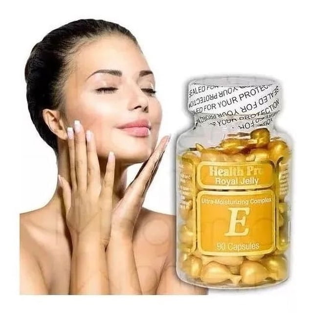 health pro royal jelly & vitamina e facial suplemento Frasco transparente con 90 cápsulas doradas y etiqueta amarilla con letra E grande y sello de seguridad; junto a modelo femenina mostrando cuello y manos sobre fondo blanco, adecuado como apoyo a la rutina de cuidado facial, libre de parabenos.