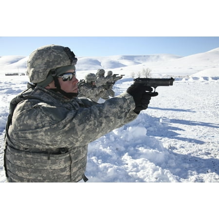 February 26 2014 - US Army Soldier fires a 9mm Berretta pistol while competing in the Army Reserve Medical Commands 2014 Best Warrior Competition on Fort Harrison Montana Poster