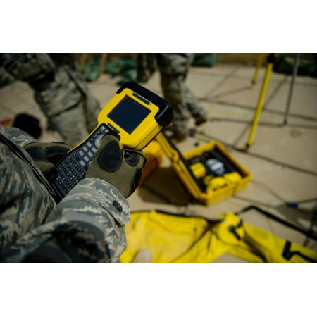 US Air Force Airman uses a satellite base station to collect data on terrain features and distances