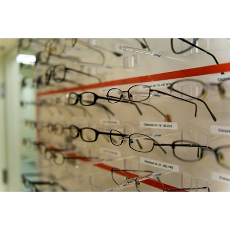 LAMINATED POSTER Prescription glasses frames line the wall of a room in the optometry clinic at the 35th Medical Grou Poster Print 24 x 36