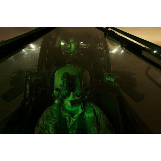 A Pilot Equipped With Night Vision Goggles In The Cockpit 