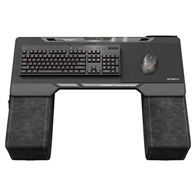 Couchmaster CYCON² Black Edition ergonomic couch gaming desk for mouse and keyboard use with PC, PS4/5, and Xbox One/Series X|S. Finished in black artificial leather, it features large cushions for forearm support, an integrated USB 3.0 hub for up to four input devices, and a 5m active USB 3.0 cable for direct PC connection without a separate power supply. Ideal for living-room gaming or working sessions.