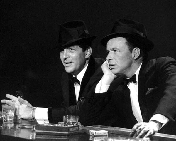 Frank Sinatra & Dean Martin sit at bar drinking & smoking cigarettes ...