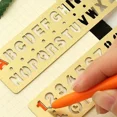 thumbnail image 4 of Regla recta hueca de Metal multifuncional, marcapáginas con patrón de letras y números, herramienta de medición de plantilla de dibujo de papelería Kawaii, 4 of 4