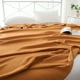 thumbnail image 1 of Manta refrescante de mezcla de algodón y rayón para quienes duermen con calor, transpirable y ligera, con regulación de temperatura para cama o sofá. Aestivo | Naranja | AESTIVO, 1 of 7