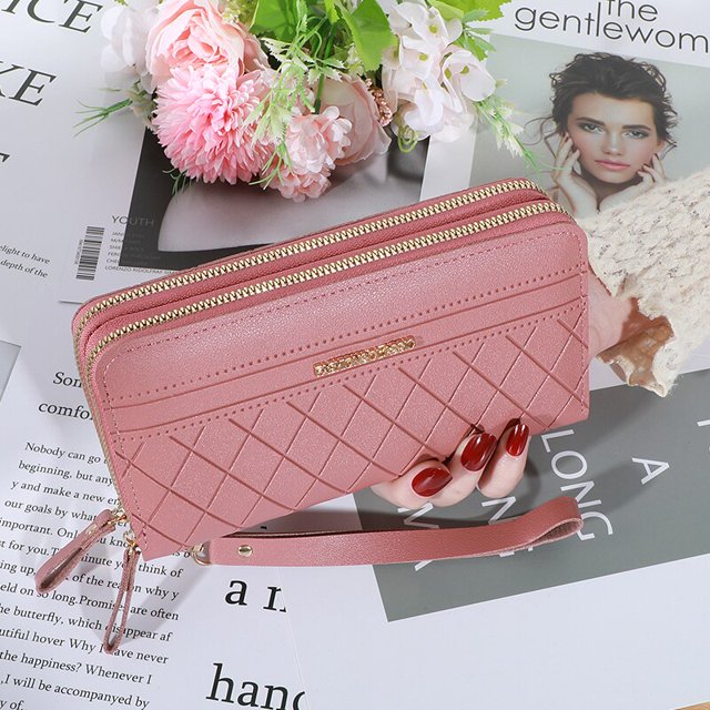 cartera larga para mujer, monedero con borlas Tan Jianjun en rosa oscuro; vista frontal 3/4 con doble cremallera dorada y trabilla de muñeca a juego, PU texturizado, patrón rombo acolchado y placa metálica con logo, dimensiones aproximadas 19 x 11 x 4 cm. También suele usarse como tarjetero y bolso de mano compacto para teléfono y efectivo.