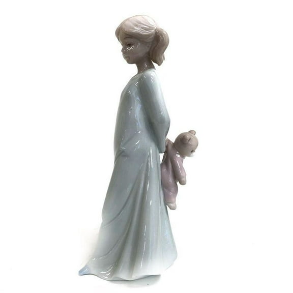 Girl Holding A Teddy Bear Figurine