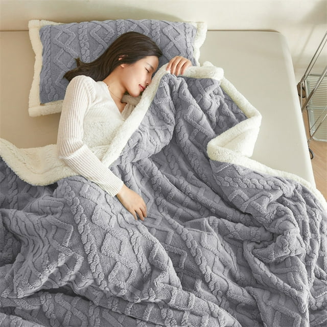 HCBY Winter Sherpa Throw Blankets in navy, measuring 78x59 inches, shown draped over a bed. The blanket features a double-sided thickened suede structure with a textured side and a soft short-suede side for enhanced warmth. Made of high-density polyester, it is lightweight, breathable, and designed to resist fading and linting. Suitable for use on beds, couches, or as a decorative home accessory.