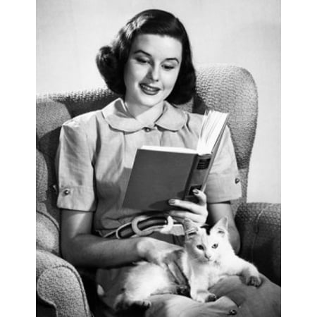 Mid adult woman reading a book with a cat sitting on her lap Canvas Art -  (24 x