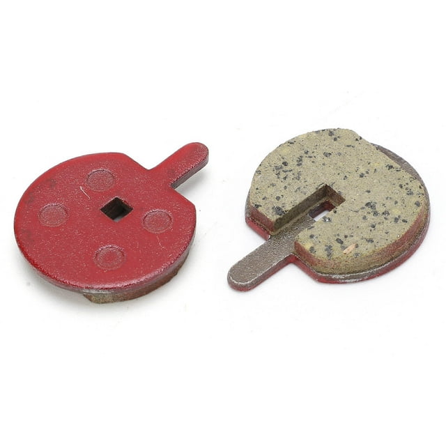 Brake Pads, Replaceable Practical Bike Brake Pads for Electric Vehicle. The image shows two round brake pads with a red backing and a resin semi-metal friction surface. Each pad features a square cutout in the center and a small tab for installation. Designed for strong braking force, silent operation, and high wear resistance. Approximate size is 28.5 x 22.5mm (1.1 x 0.9in).