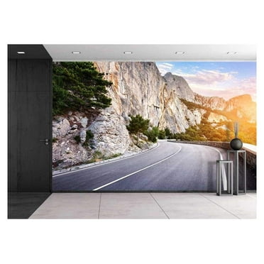 wall26 - Asphalt Road in Summer Forest at Sunset. Crimean Mountains - Removable Wall Mural | Self-Adhesive Large Wallpaper - 66x96 inches