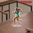 thumbnail image 4 of Rotating acrylic display features a runner accelerating in the final stretch with vibrant colors and intricate details against a white background, emphasizing her determination, 4 of 8