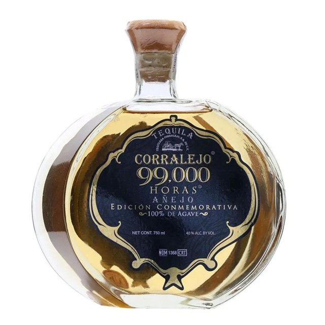 pack de 6 tequila corralejo 99,000 horas añejo 750 ml — imagen de una botella frontal redonda con etiqueta negra que muestra Corralejo 99,000 Horas Añejo y texto de edición conmemorativa, vidrio transparente con líquido ámbar y tapón de corcho; fondo blanco; a menudo usado en catas y celebraciones.