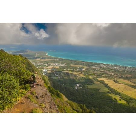 A man standing on the edge of a cliff on the Kuliouou Ridge Trial enjoys the view of Oahus windward side and the town of Waimanalo as the clouds roll in on a summers day Waimanalo Oahu Hawaii United (Best Clogs For Standing All Day)