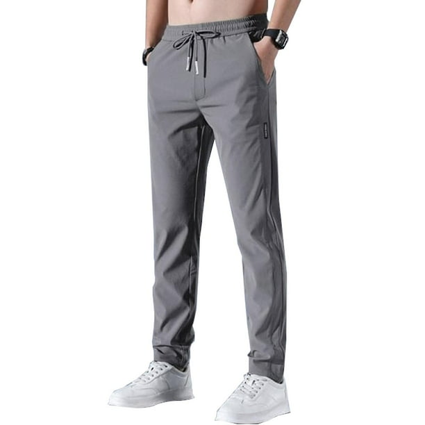 Pantalones elásticos de secado rápido para hombre de color sólido con absorción de humedad y cintura expandible