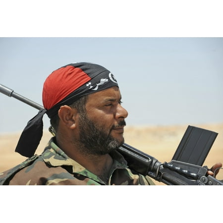 A rebel fighter armed with a FN FAL battle rifle mans a checkpoint in Ajdabiya Libya Poster