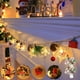 thumbnail image 1 of Hilo de luces navideñas LED con copos de nieve y campanas - Luces verdes decorativas de 200 cm alimentadas por pilas para decoración navideña interior, 1 of 6
