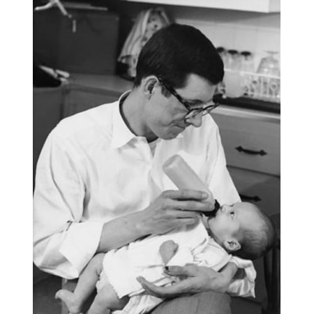 Mid adult man feeding his baby with a baby bottle Canvas Art -  (24 x 36)