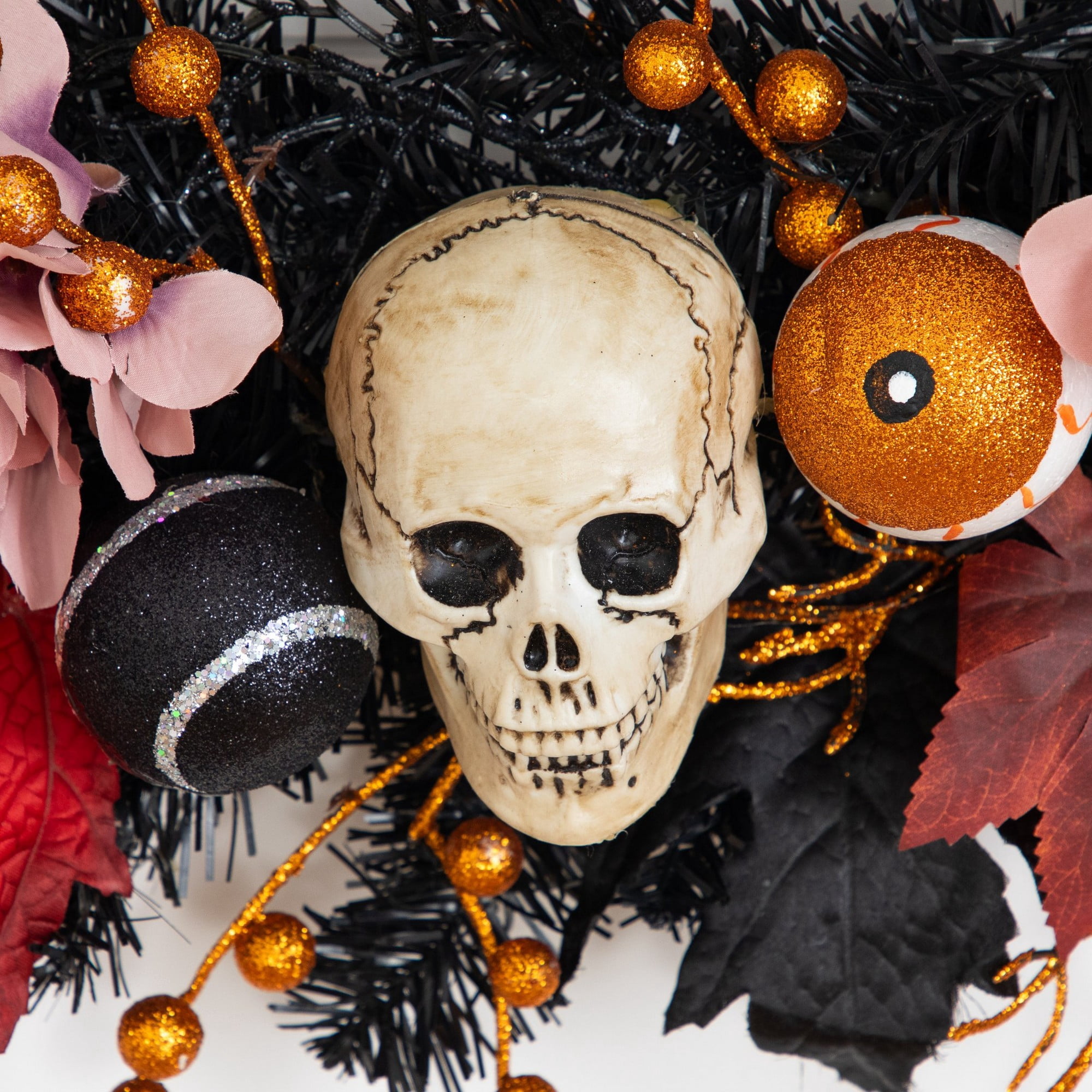 24in. Artificial Halloween Wreath with Skulls, Spiders and Pumpkins