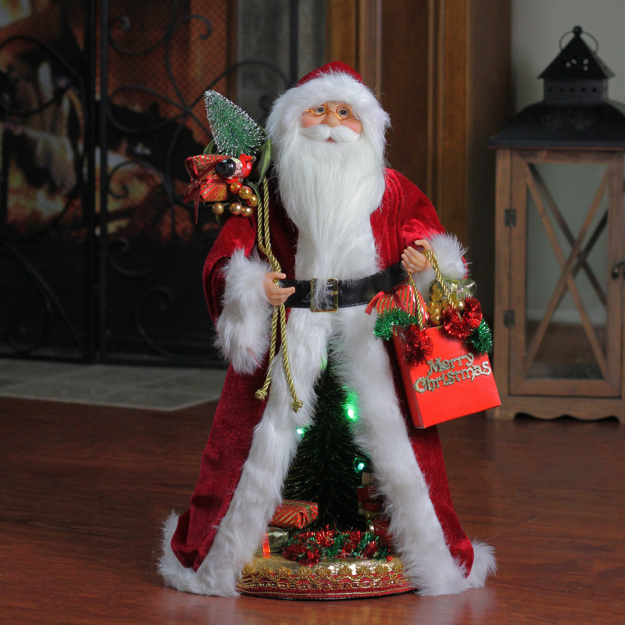 Santa Claus wearing a traditional red suit with white fur trim, a wide  black belt, and shiny black boots. He carries a large, overflowing sack of  toys on his back - Stable