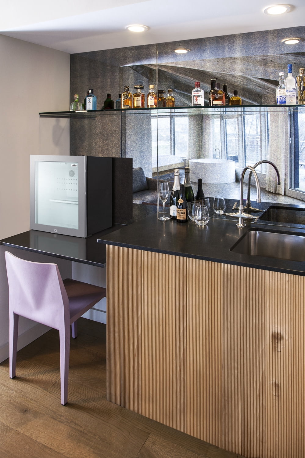 Commercially listed 5.5 cu.ft. counter height beverage center in a 24" footprint, with black cabinet, glass door, thin stainless steel handle, and lock