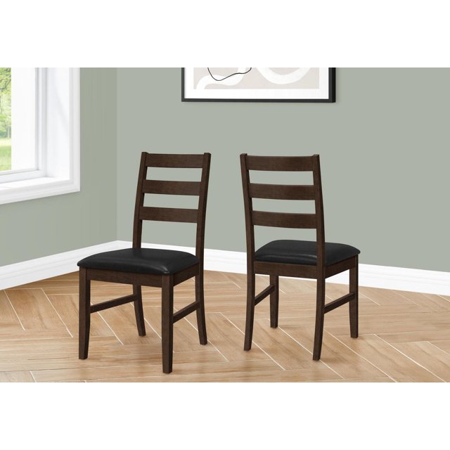 Monarch Specialties dining chair set of 2, 37-inch height, with brown solid wood frames and black leather look upholstered seats, featuring a transitional design with slat back support, placed on light wood herringbone flooring against muted green walls, suitable for kitchen or dining room seating.
