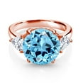 thumbnail image 2 of Gem Stone King 18K Rose Gold Plated Silver Swiss Blue Topaz and White Moissanite 3-Stone Ring for Women (7.94 Cttw, Round 12MM, Trillion 5MM, Size 7), 2 of 3